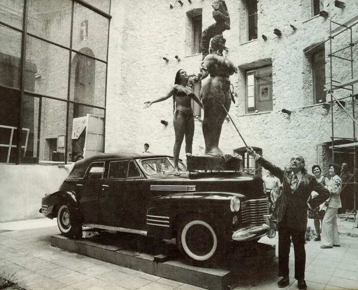 Salvador Dali points out details of Ernst Fuchs sculpture in the courtyard of the theater museum in Figueras